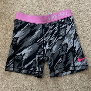 Nike Pros with grey and black streaks in a size large.